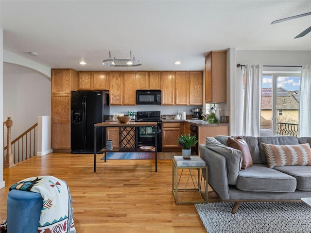 kitchen with ceiling fan, light wood-type flooring, and black appliances