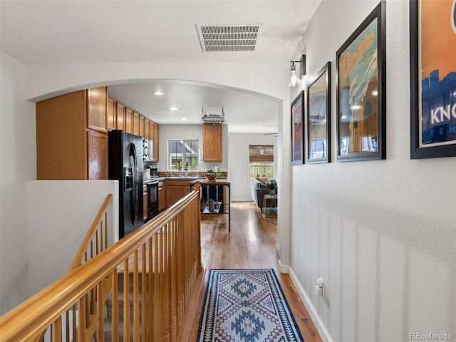 hallway with hardwood / wood-style flooring