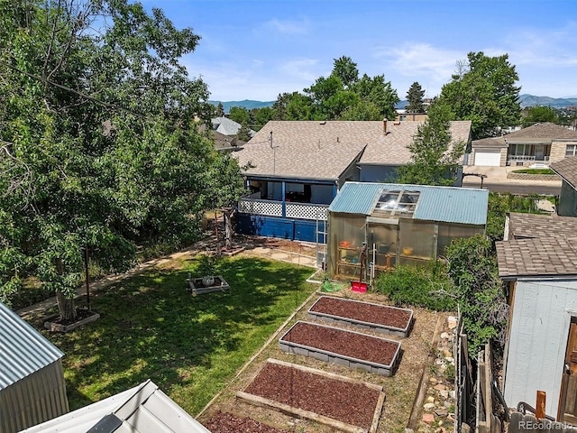 3306 S Logan St, Englewood, CO 80113 - view of grassy yard featuring an exterior structure, a garden, an outdoor structure, and a mountain view