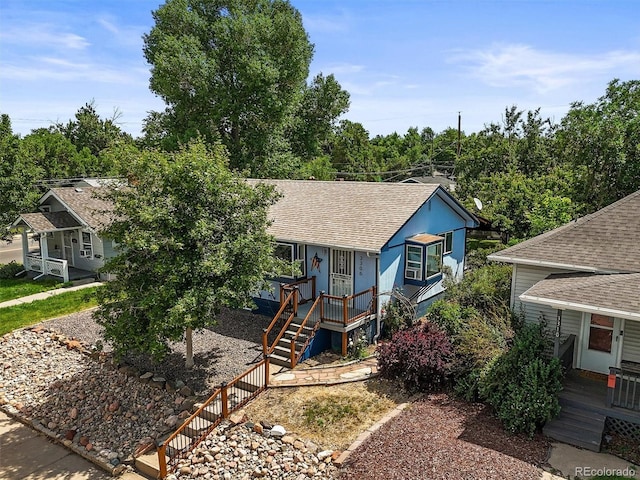 3306 S Logan St, Englewood, CO 80113 - view of front of property with covered porch, stairs, and roof with shingles