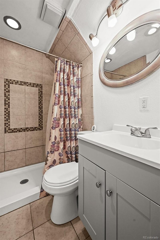 3306 S Logan St, Englewood, CO 80113 - bathroom featuring vanity, tile patterned flooring, and a shower stall