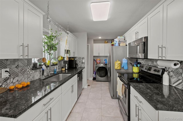 1944 Carmel Dr, Colorado Springs, CO 80910 - kitchen with appliances with stainless steel finishes, decorative backsplash, white cabinetry, and light tile patterned flooring
