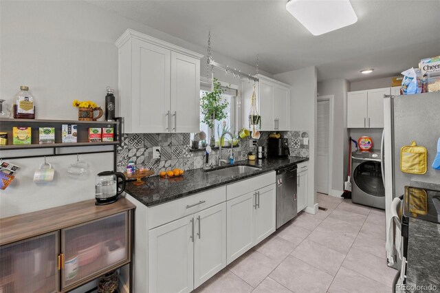 1944 Carmel Dr, Colorado Springs, CO 80910 - kitchen with stainless steel dishwasher, washer / clothes dryer, black range with electric cooktop, white cabinetry, and tasteful backsplash