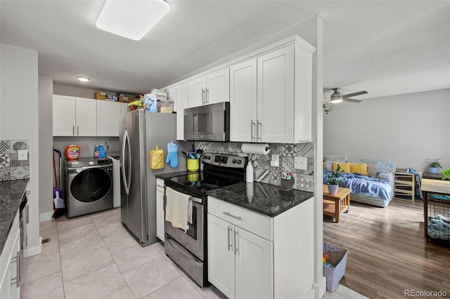 1944 Carmel Dr, Colorado Springs, CO 80910 - kitchen with appliances with stainless steel finishes, washer and clothes dryer, white cabinets, ceiling fan, and dark stone counters
