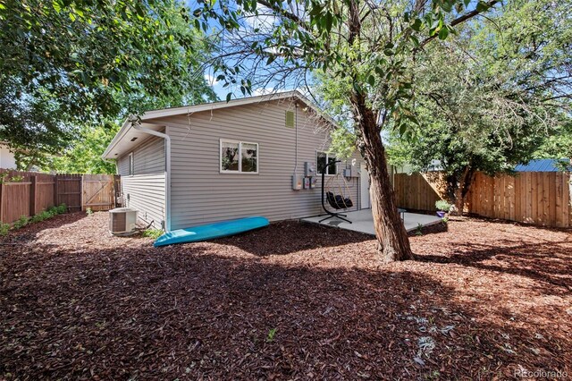 1944 Carmel Dr, Colorado Springs, CO 80910 - rear view of house featuring a fenced backyard and a patio area