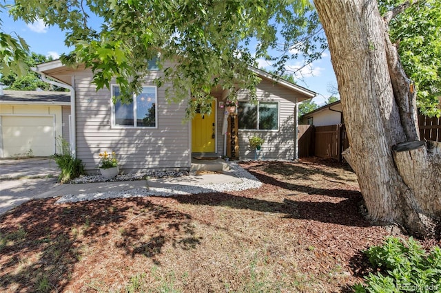 1944 Carmel Dr, Colorado Springs, CO 80910 - view of front of house with an attached garage, driveway, and entry steps