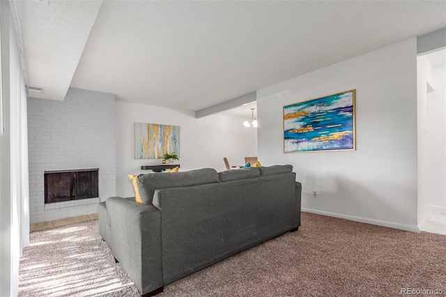 living room with carpet, beamed ceiling, and a fireplace