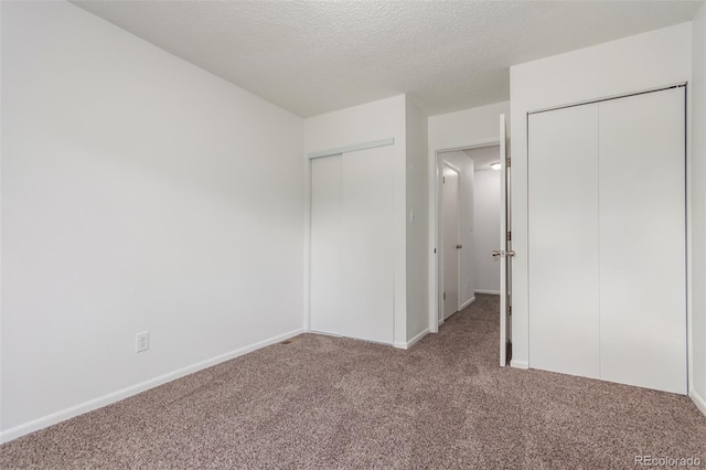 unfurnished bedroom featuring a textured ceiling and carpet flooring