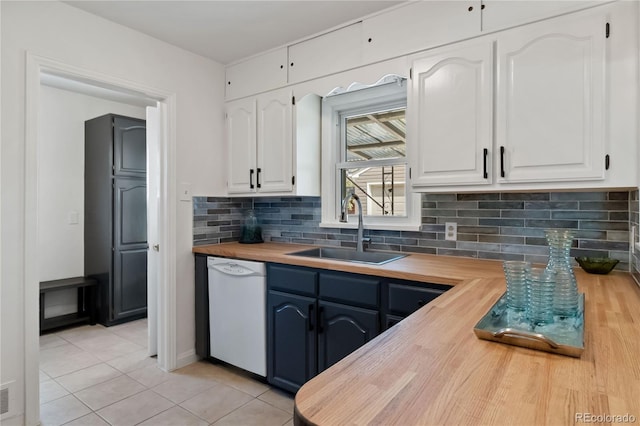 kitchen with butcher block countertops, dishwasher, a sink, white cabinets, and light tile patterned flooring