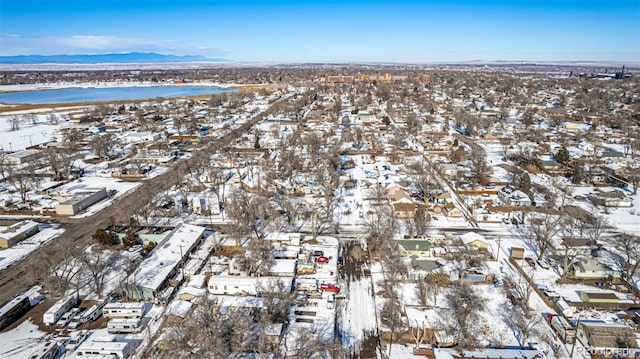 snowy aerial view featuring a water view