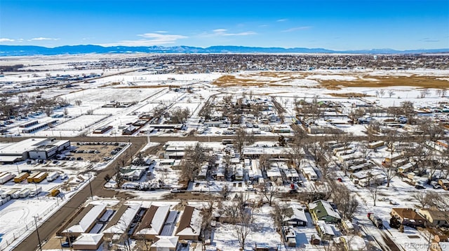 snowy aerial view featuring a mountain view