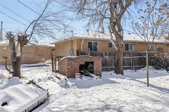 view of snow covered rear of property