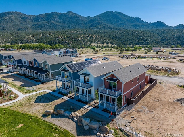 drone / aerial view featuring a residential view and a mountain view