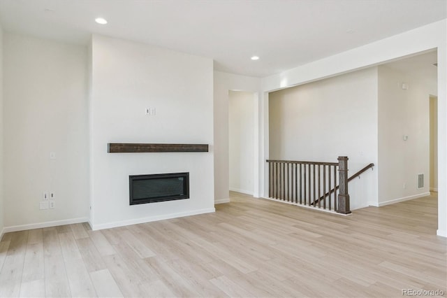 unfurnished living room featuring light wood-type flooring