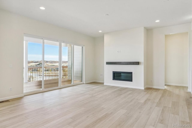 unfurnished living room with light wood-type flooring