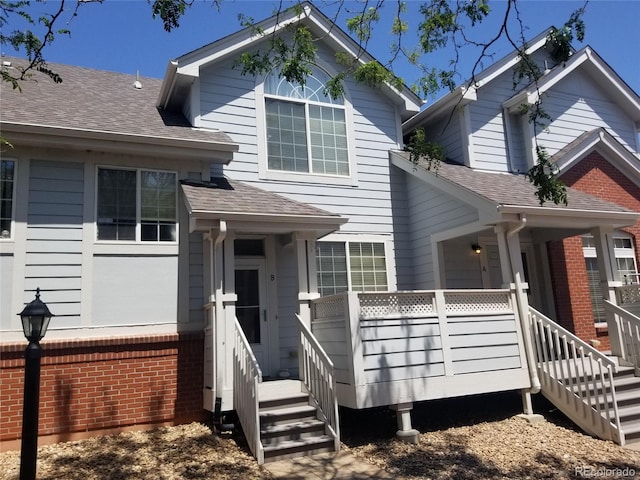 2240 S Pagosa Ct Unit B, Aurora, CO 80013 - view of front of house featuring brick siding, roof with shingles, and stairs