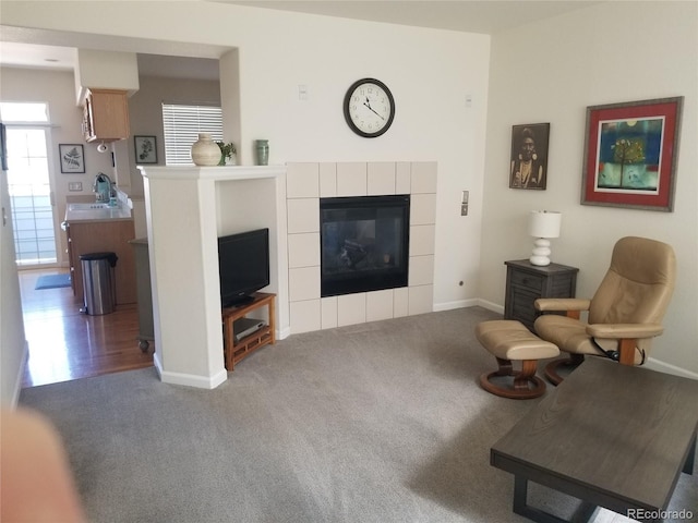 2240 S Pagosa Ct Unit B, Aurora, CO 80013 - living room featuring carpet flooring, a fireplace, and baseboards