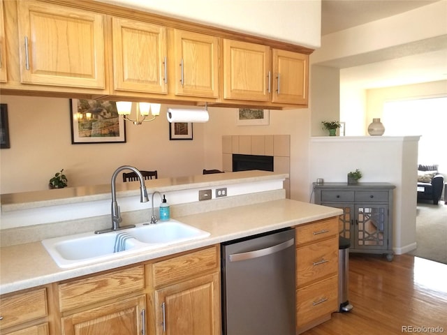 2240 S Pagosa Ct Unit B, Aurora, CO 80013 - kitchen with dishwasher, a sink, wood finished floors, light countertops, and a fireplace
