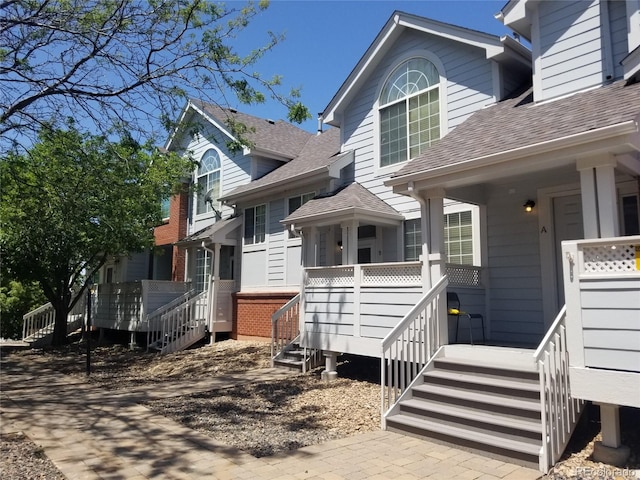 2240 S Pagosa Ct Unit B, Aurora, CO 80013 - view of side of property with a shingled roof and stairway