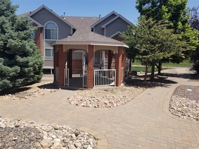 2240 S Pagosa Ct Unit B, Aurora, CO 80013 - view of front of house featuring brick siding and roof with shingles