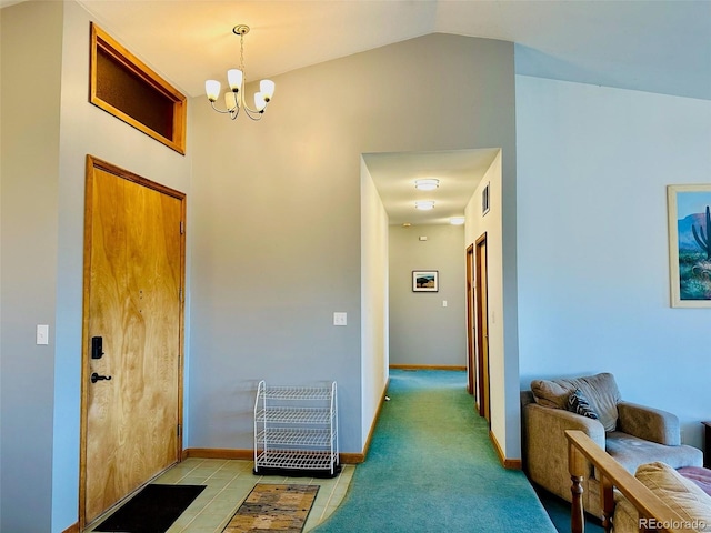 hallway with light carpet, vaulted ceiling, and an inviting chandelier