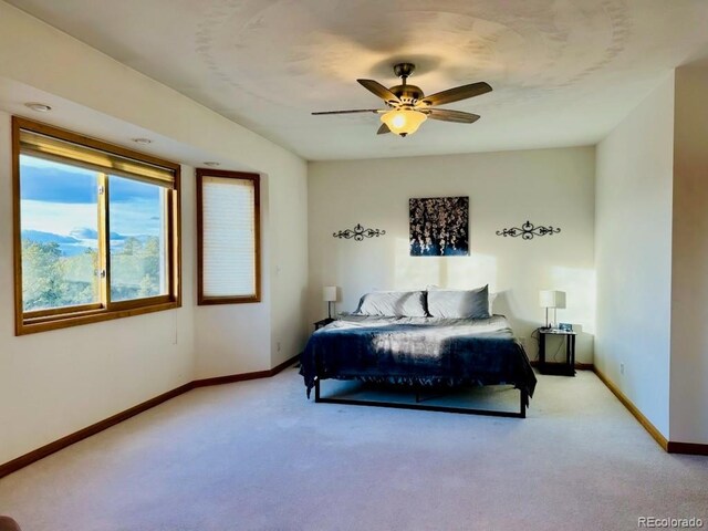 bedroom with light colored carpet and ceiling fan