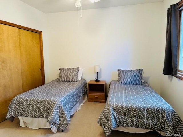 carpeted bedroom with a closet