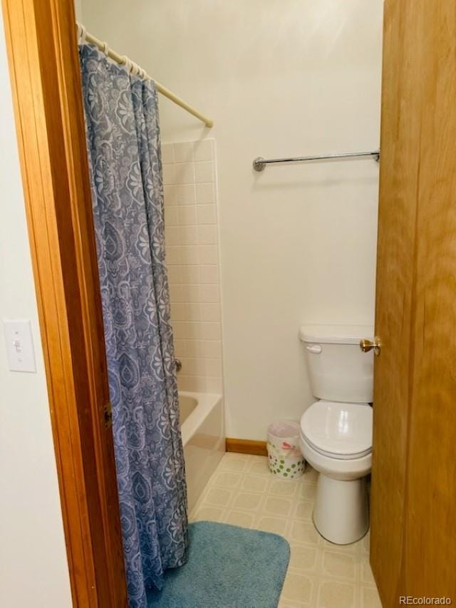 bathroom with shower / bath combination with curtain and toilet