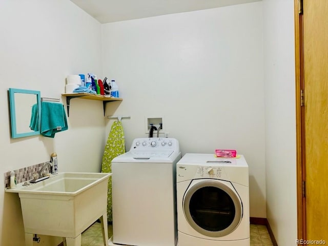 washroom with sink, light tile patterned floors, and independent washer and dryer