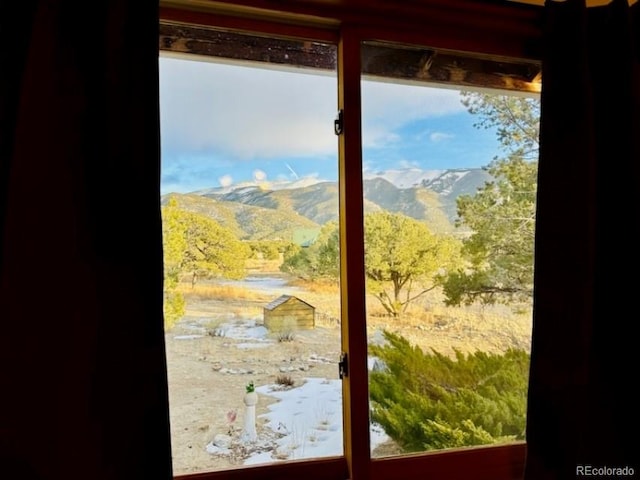 doorway to outside with a mountain view