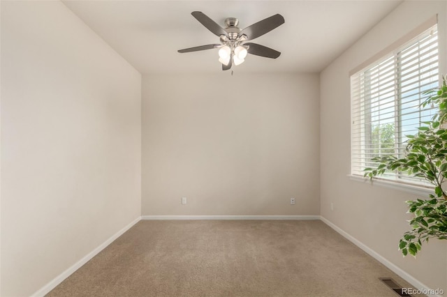 unfurnished room featuring ceiling fan and carpet