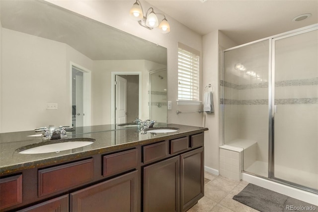 bathroom with an enclosed shower, dual bowl vanity, and tile flooring