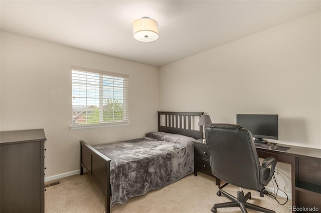 bedroom featuring light carpet