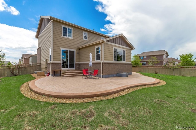 back of property featuring a patio and a lawn