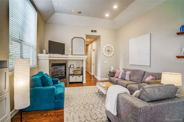 2479 S High St, Denver, CO 80210 - living room featuring wood finished floors, a tile fireplace, recessed lighting, and lofted ceiling