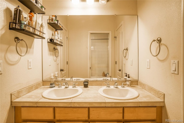 2479 S High St, Denver, CO 80210 - full bath featuring double vanity, a textured wall, and a shower