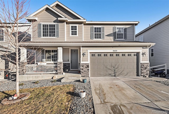 view of front of property featuring a porch and a garage