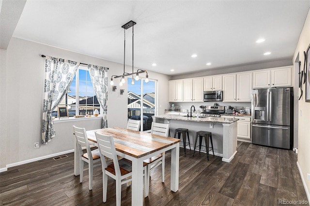 dining area featuring dark hardwood / wood-style floors and sink