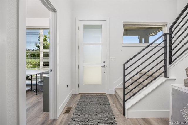 21482 E 60th Ave, Aurora, CO 80019 - entryway featuring wood finished floors, stairway, and baseboards