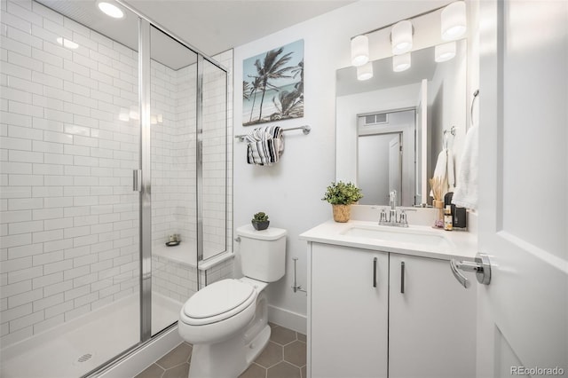 21482 E 60th Ave, Aurora, CO 80019 - bathroom with toilet, vanity, a shower stall, and tile patterned floors