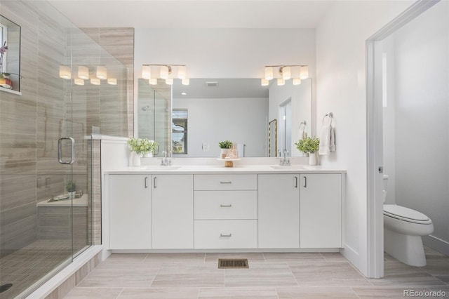 21482 E 60th Ave, Aurora, CO 80019 - full bath featuring double vanity, a stall shower, and toilet