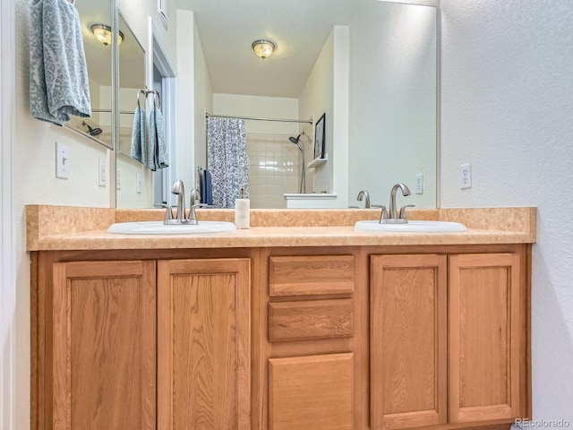 15700 E Jamison Dr Unit 7-203, Englewood, CO 80112 - full bathroom featuring double vanity, a shower with shower curtain, and a textured wall