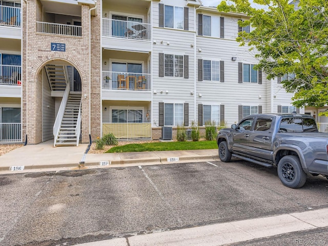 15700 E Jamison Dr Unit 7-203, Englewood, CO 80112 - view of building exterior with uncovered parking and stairway