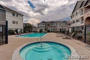 15700 E Jamison Dr Unit 7-203, Englewood, CO 80112 - community pool featuring a hot tub, a patio area, and a residential view