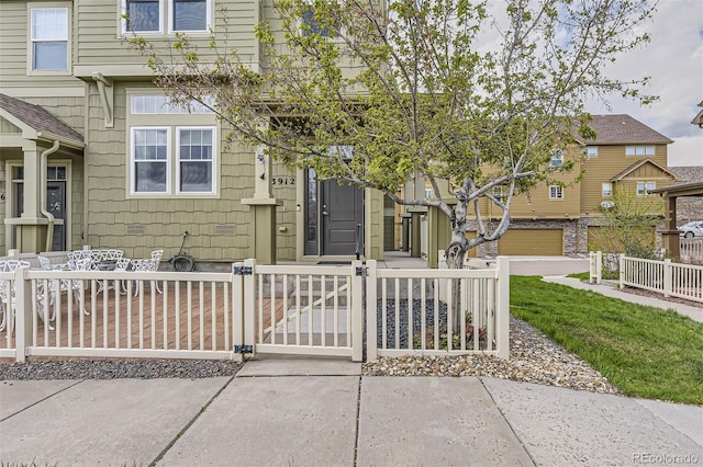 view of front of property featuring a fenced front yard and a gate