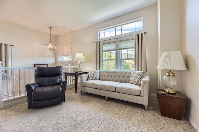 living room with carpet flooring, baseboards, and a healthy amount of sunlight