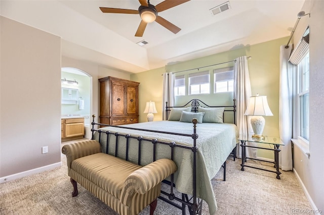bedroom featuring visible vents, multiple windows, and light carpet