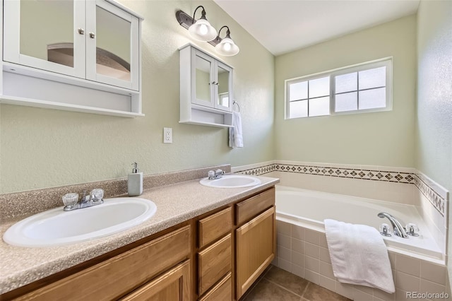 bathroom featuring double vanity, tile patterned flooring, a sink, and a bath