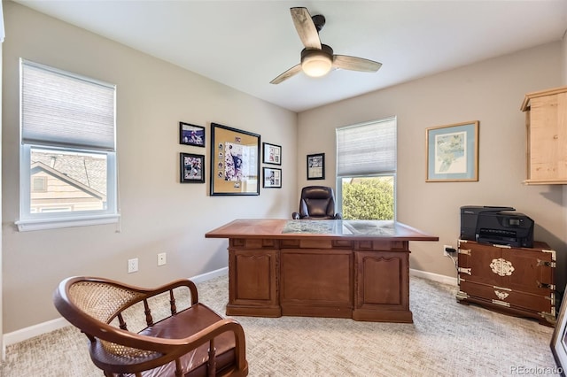 office with ceiling fan, light carpet, and baseboards