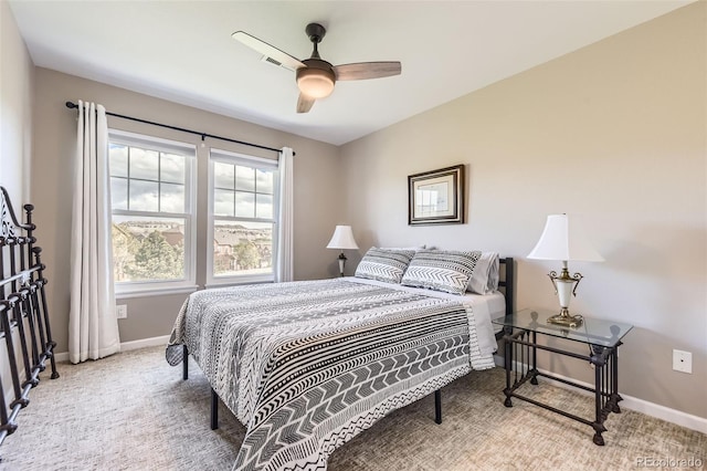 bedroom featuring baseboards, ceiling fan, and light carpet
